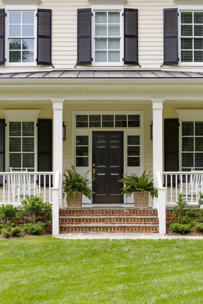 White House Black Door Black Shuttered Windows Covered Porch