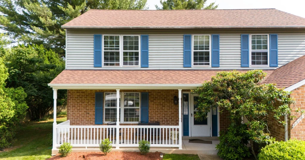 Grey Siding Red Shingle Roof Blue Shutter House Covered Porch Facade 2500x1308