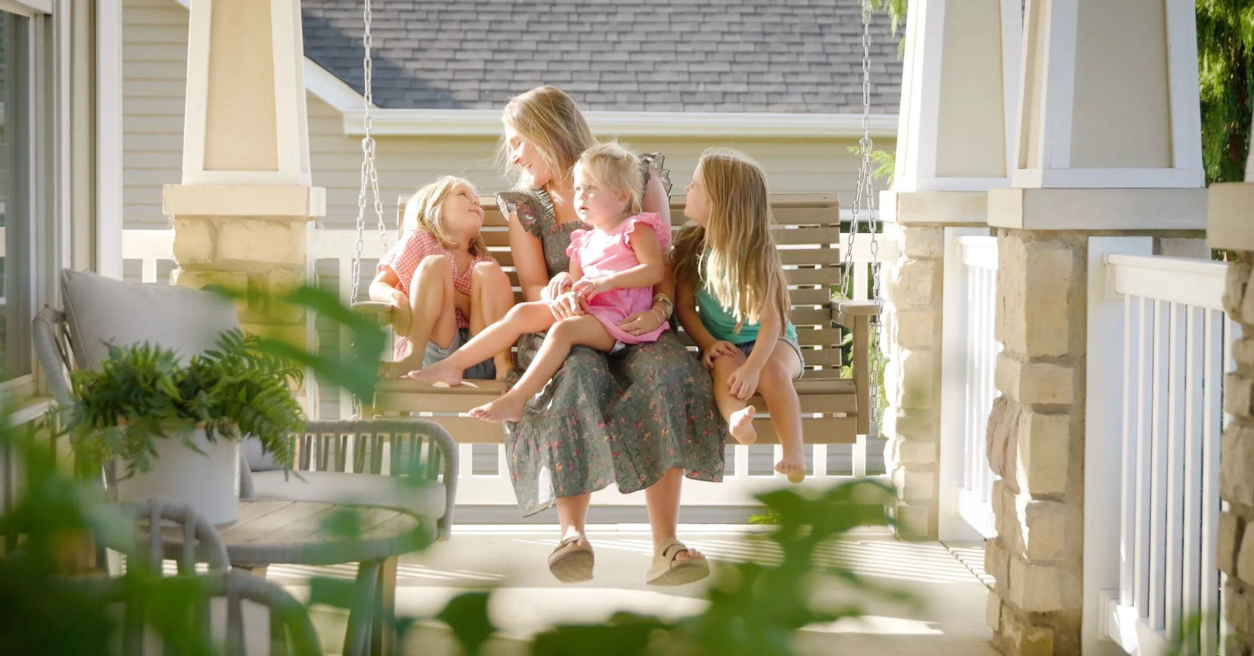 Mother and daughters on a porch swing